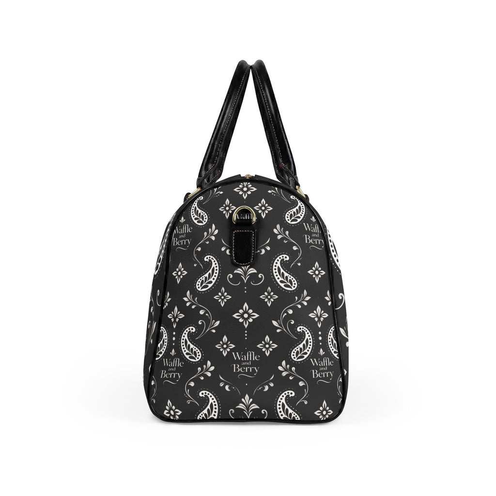 Black Paisley travel bag, end view showing the patterned side panel and shoulder-strap attachment ring.
