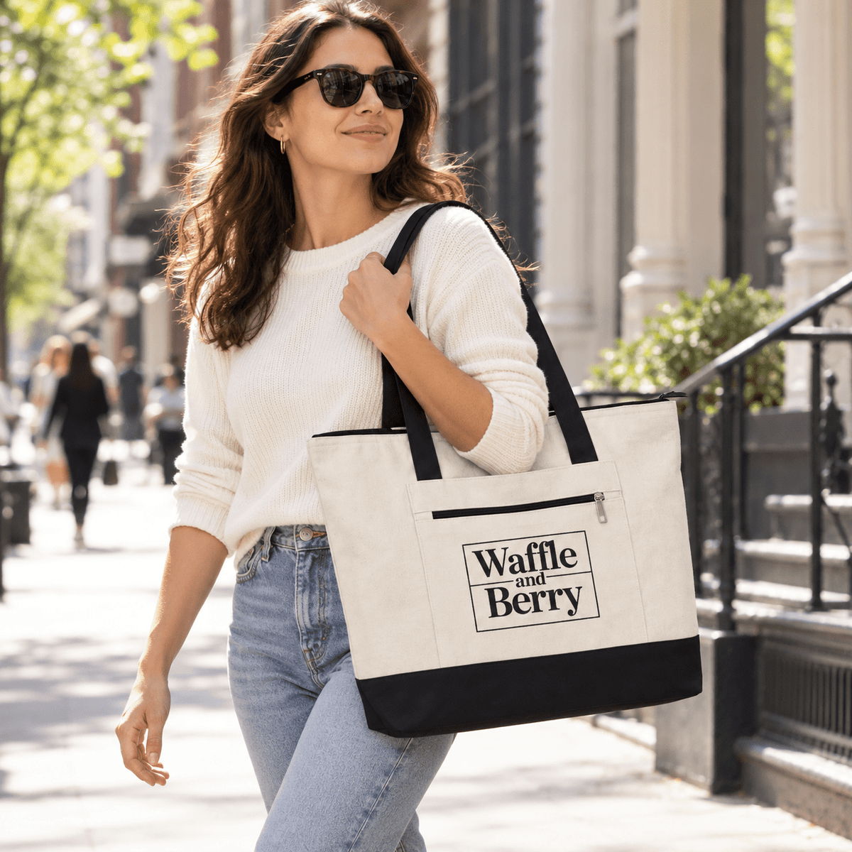 Illustrative model carrying the Natural/Black Waffle and Berry zippered canvas tote on a New York street.