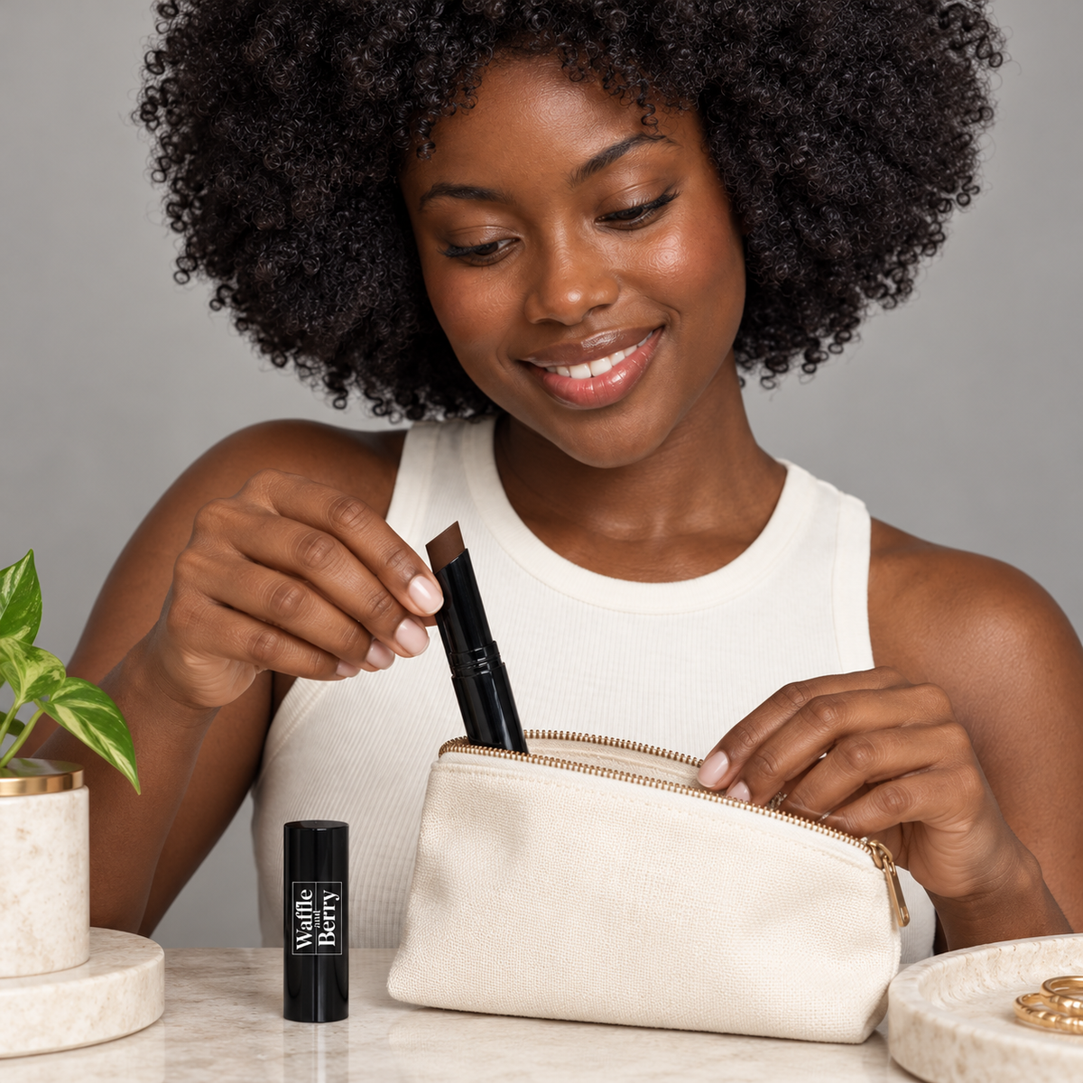 AI-generated editorial illustration of Choco DC2 concealer with fictional model Simone, organizing beauty essentials. Not evidence of coverage or color payoff. Styling props not included; consult authentic product image and supplier shade chart.