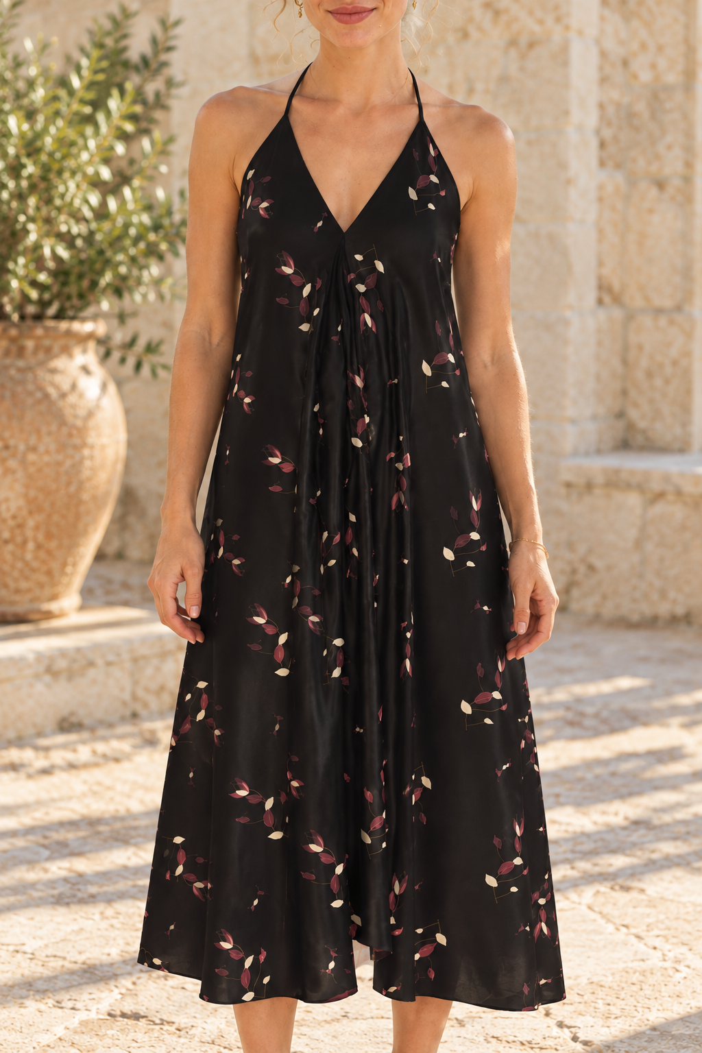 AI styling preview: Evening Petals Halterneck Dress, close neckline and botanical print view. Illustrative fit and print placement; refer to original supplier product views and size guide.