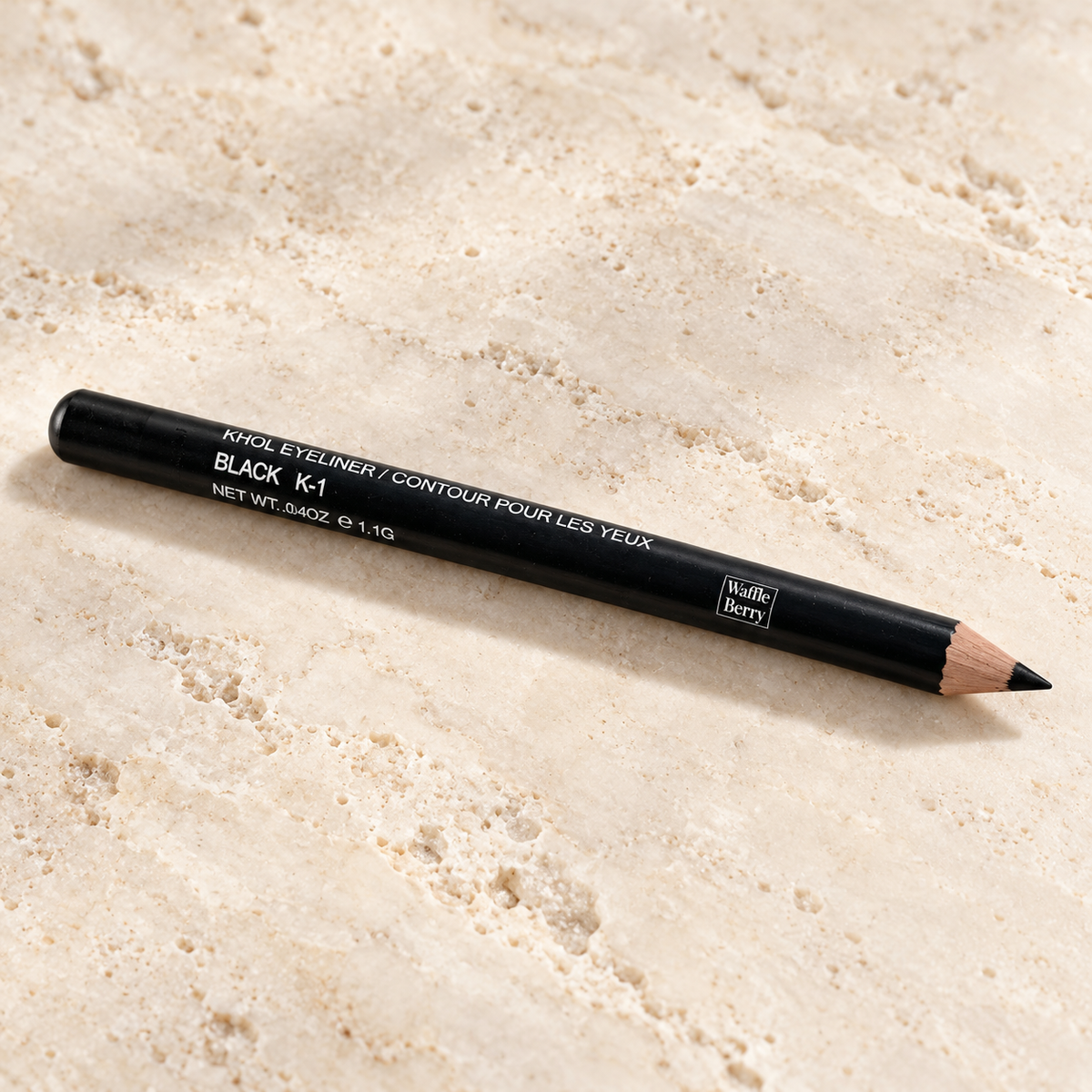 AI editorial product illustration of Black K-1 kohl pencil on ivory stone; supplier photo remains the product reference.