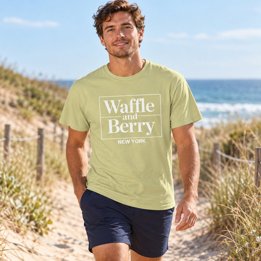 Illustrative model wearing the Pistachio Waffle and Berry NEW YORK T-shirt on a sandy coastal path.