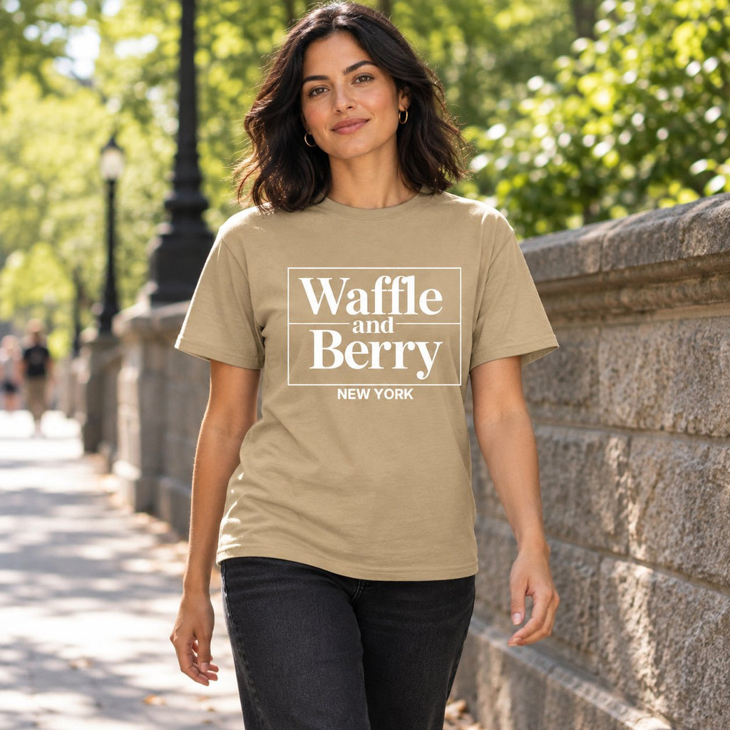 Illustrative model wearing the Tan Waffle and Berry NEW YORK T-shirt beside a New York park.