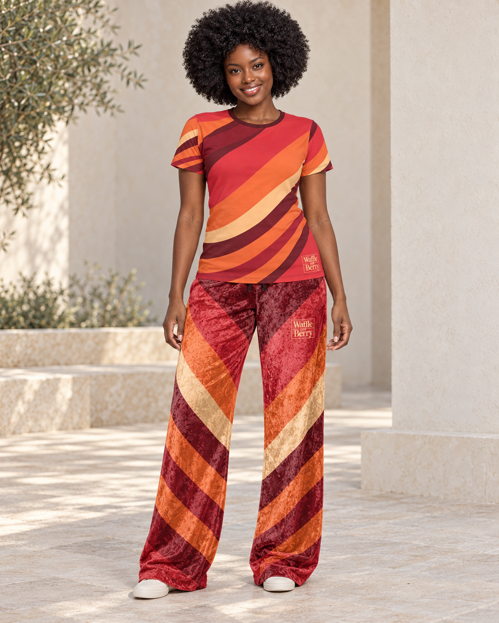 AI styling illustration: fictional cast model Simone wearing Solar Current women's T-shirt and matching wide-leg velour pants, sold separately.