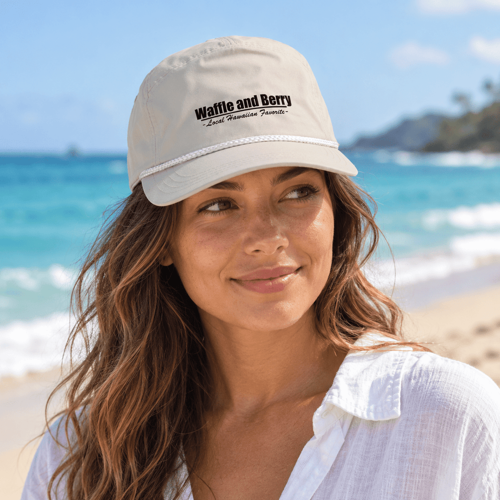Cream Waffle and Berry rope cap worn by a model beside the ocean — illustrative lifestyle image