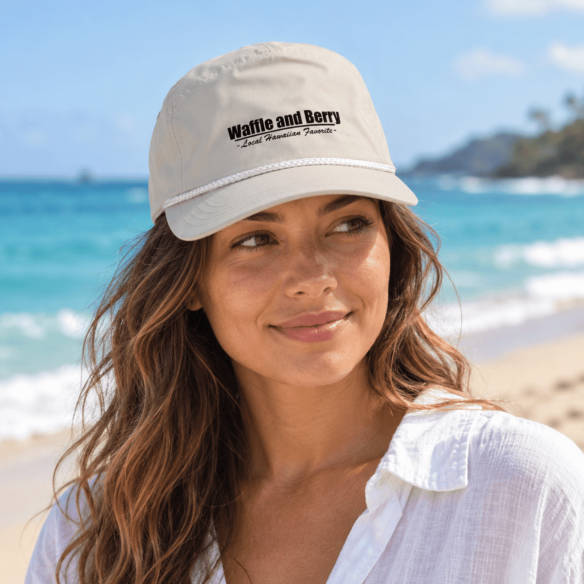 Cream Waffle and Berry rope cap worn by a model beside the ocean — illustrative lifestyle image
