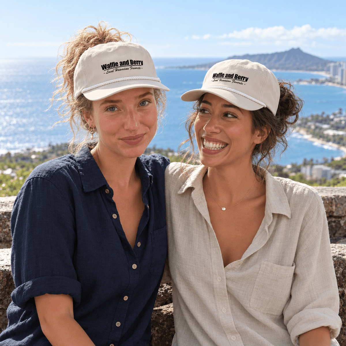 Two sisters wearing cream Waffle and Berry rope caps at a coastal overlook