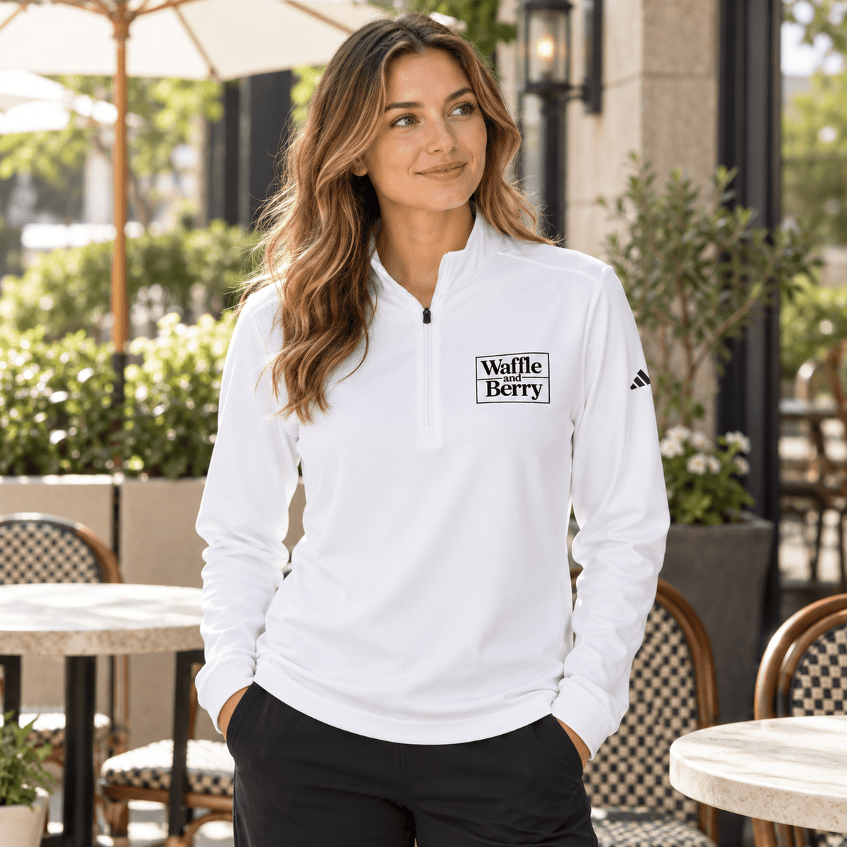 AI model illustration: woman wearing white Waffle and Berry adidas quarter-zip at a cafe